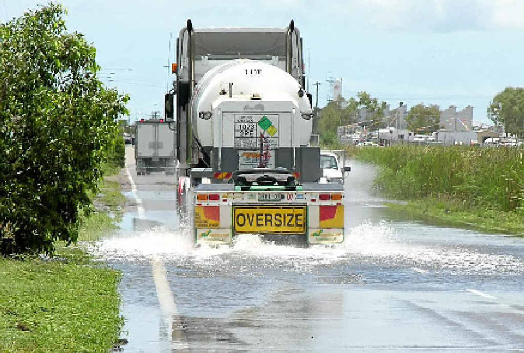 ABOVE AND BELOW: Trucks cross a flooded Blakey’s Crossing near Townsville. ABOVE AND BELOW: Trucks cross a flooded Blakey’s Crossing near Townsville.